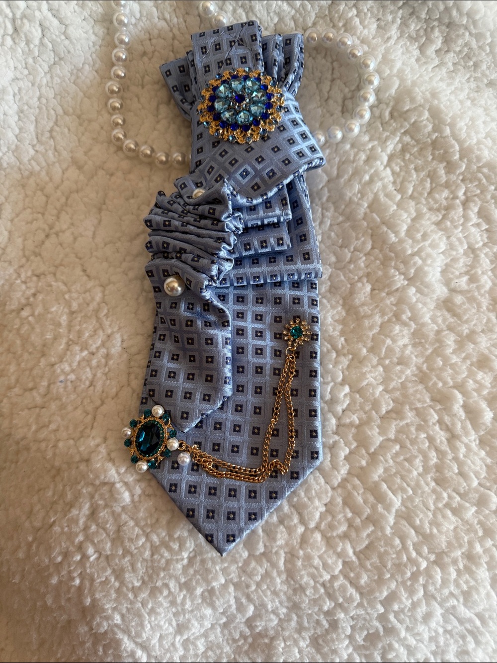 Light Blue Patterned Tie with Gold and Teal Brooch Accents